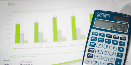 A worksheet with diagrams in green bars and a calculator on the right.